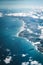 Flight over the coast of Portugal Lissabon region . Aerial view through the airplane window with clouds water and