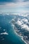 Flight over the coast of Portugal Lissabon region . Aerial view through the airplane window with clouds water and