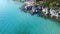 Flight over the exotic turquoise sea with massive rocks on the coast. Aerial view