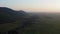 Flight over fields with a sunset in the background