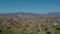 Flight over the flowering almond garden against the backdrop of the mountains