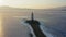 Flight over the frozen sea and drone view of Tokarevsky lighthouse at dawn