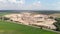 Flight over giant clay iron ore quarry. Huge open mining with mounds of minerals. Large industrial sand quarry