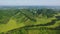 Flight over green hills, meadows, valleys and forests. Amazing bird's eye view of the national park.