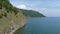 Flight over Lake Baikal. Drone video 4k footage. Lake and green forest on the shore. Landscape. Coastline.