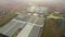 Flight over a large agro-industrial complex. Large agricultural complex. Industrial greenhouses for growing vegetables