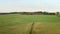 Flight over large green fields