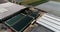 Flight over a large greenhouse. Growing vegetables in greenhouses. Large modern greenhouse. greenhouses aerial view