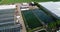 Flight over a large greenhouse. Growing vegetables in greenhouses. Large modern greenhouse. greenhouses aerial view