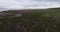 A flight over the marshy shore of a large lake. Near the water.