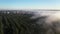 Flight over the misty forest at dawn.