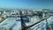 Flight over the railroad. A train runs along the rails. Winter industrial landscape. Aerial photography