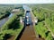 Flight over the river. Passage of hydraulic locks on the channel by commercial cargo ship