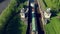 Flight over the river. Passage of hydraulic locks on the channel by commercial cargo ship