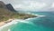 Flight over rocky coast of tropical island of Oahu Hawaii. View of Sandy Beach. Pacific Ocean Coastline. White clouds