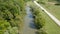 Flight over a small river with a kayak rowing in the middle