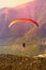 The flight of paragliders in the highlands. Paragliding at dawn. Taking photos from a height.