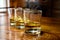 Flight of Scottish whisky, tasting glasses with variety of single malts or blended whiskey spirits on distillery tour in pub in