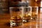 Flight of Scottish whisky, tasting glasses with variety of single malts or blended whiskey spirits on distillery tour in pub in