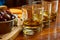 Flight of Scottish whisky, tasting glasses with variety of single malts or blended whiskey spirits on distillery tour in pub in