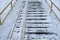 Flight of stairs on street under snow. Winter day in the city. Traumatic place, slippery steps for descent and ascent. High risk