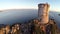 Flight and takeoff over old tower with background of the sea and islands. Tour de la Parata, Ajaccio, Corsica. Aerial pano