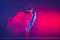 Flight. Young sportive beautiful girl, hip-hop dancer dancing hip hop isolated on purple background in pink neon light