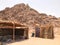 A flimsy, dilapidated decrepit, fragile, fragile poor dwelling, a Bedouin building made of straw, twigs in a sandy hot desert in t