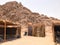 A flimsy, dilapidated decrepit, fragile, fragile poor dwelling, a Bedouin building made of straw, twigs in a sandy hot desert in t