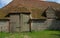 Flint built barn with huge wood double doors.