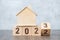 Flip 2022 to 2023 block with house model. real estate, Home loan, tax, investment, financial, savings and New Year Resolution