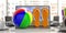 Flip flops and beach ball on a laptop, blur office background. 3d illustration