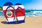 Flip flops with Costa Rican flag on the beach. Costa Rica resorts, vacation, tours, travel packages concept. 3D rendering