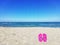 Flip-flops in the foreground and sea in the background