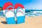 Flip flops with Luxembourgish flag on the beach. Luxembourg resorts, vacation, tours, travel packages concept. 3D rendering