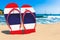 Flip flops with Thai flag on the beach. Thailand resorts, vacation, tours, travel packages concept. 3D rendering