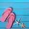 Flipflops starfish summer tropical sunny beach blue wood background border