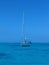 Flipped vertical shot of a yacht in the calm blue sea