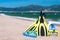 Flippers, diving mask, snorkeling accessories on the beach during sunny day closeup against sea background. Background for summer