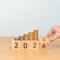 flipping 2023 to 2024 year block with Coins stack. Money, Budget, tax, investment, financial, savings and New Year Resolution