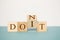 Flipping one wooden cube to change the word Don`t for Do it on Isolated background