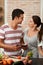 Flirtatious foodies. an affectionate young couple using their tablet in the kitchen.