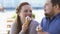 Flirting young woman touching boyfriend nose with ice-cream, playful mood