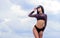 Flirty beauty. Girl attractive sexy body posing sky background. Booty woman wear bikini. Sporty girl sexy body. Resort