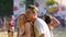 Flirty woman dancing with smiling handsome man at holi color festival, slow-mo