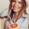 Flirty woman in hat hold sunglasses and grapefruit