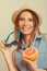 Flirty woman in hat hold sunglasses and grapefruit