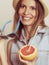 Flirty woman in hat hold sunglasses and grapefruit