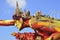 Float in Flower parade depicting a man carrying a city on his head and back