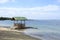 Floating beach bamboo and palm cottage parasol on white sand coast